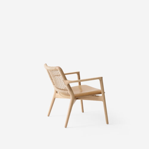 Cabin Lounge chair in light oak with apadded aniline leather cushion in sand. Side view